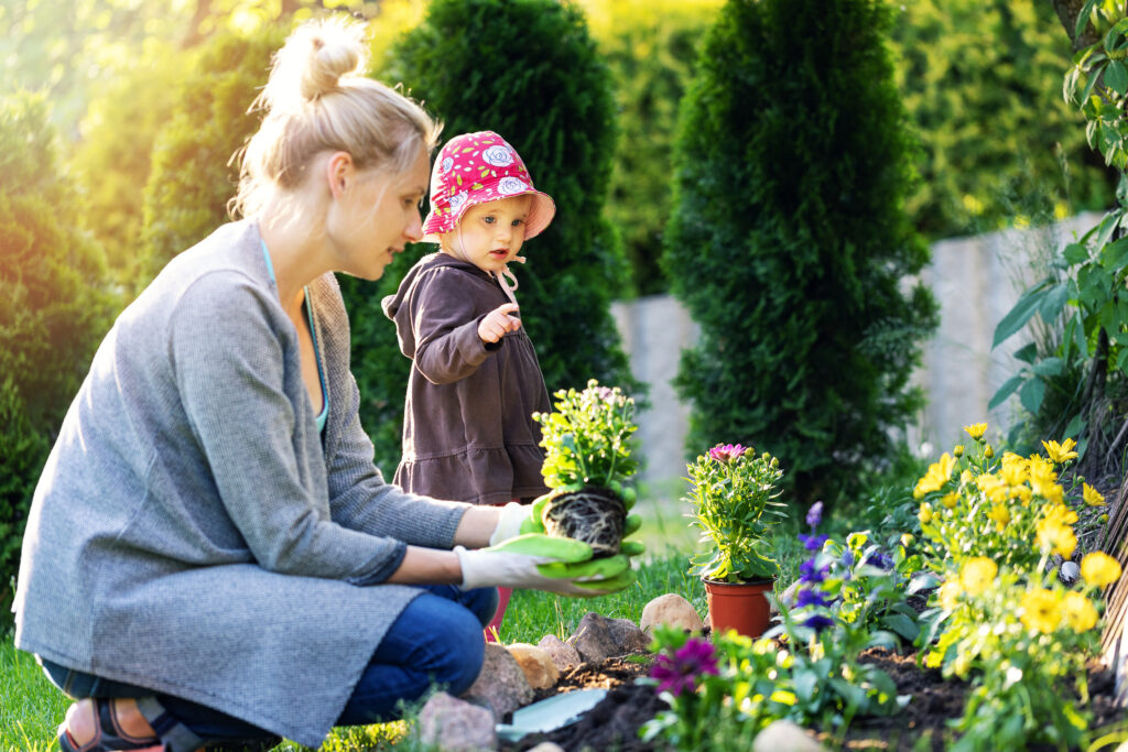 Mother and young girl plant spring gardens